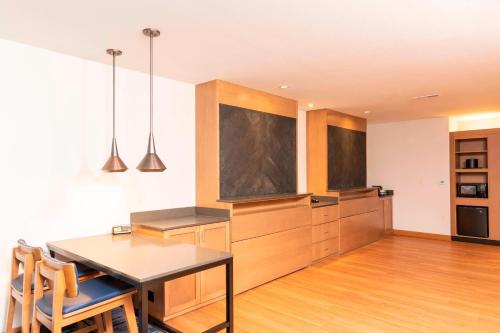 a kitchen with a table and a dining room at Fairfield Inn & Suites by Marriott Fair Oaks Farms in Fair Oaks