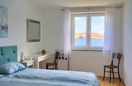 a bedroom with a window and a desk and a bed at Apartment Frane in Baška