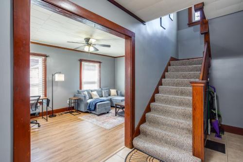 a staircase leading to a living room with a couch at Spacious Home with In-Unit Laundry, Parking, 1GB WiFi, & Patio Deck in Rochester