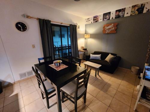 a living room with a table and chairs and a couch at At Home CdelU in Concepción del Uruguay