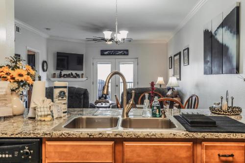 a kitchen with a sink and a living room at Mvc - Unit 5606 - Mountain Breeze 2 in Pigeon Forge