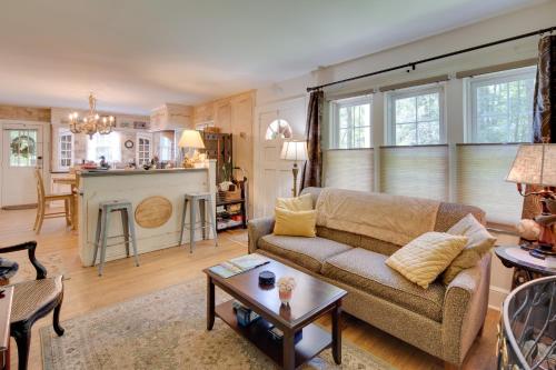 a living room with a couch and a table at 7 Mi to The Biltmore Le Canard Cottage with Porch in Arden
