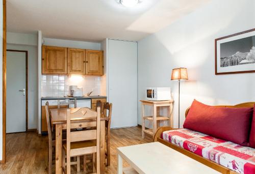 a living room with a couch and a table at Résidence Le Bois de la Reine in Super Besse