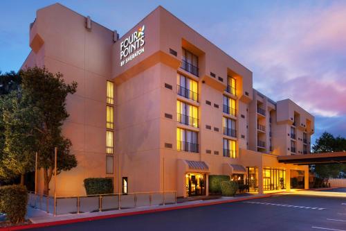 een hotelgebouw met een bord erop bij Four Points by Sheraton San Jose Airport in San Jose