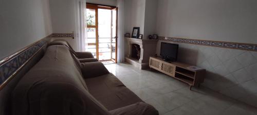a living room with a couch and a television at Vista do Farol in Gafanha da Nazaré