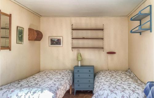 a bedroom with two beds and a blue dresser at Lovely Home In Ljuster With Wifi in Norra Ljustero