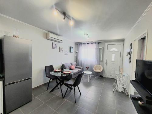 a living room with a table and a couch at Villa Gardiki for2 in Halikounas
