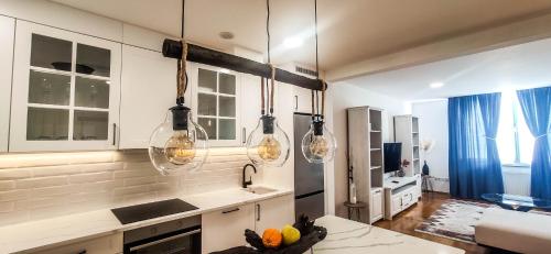 a kitchen with three lights hanging over a counter at Americano in Brčko