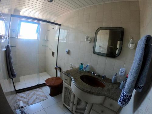 a bathroom with a sink and a shower at Suíte em Luna & Line in Salvador