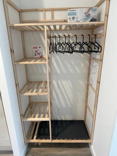 a kitchen shelving unit with a bunch of wine racks at Jardin privé 1 in La Ravoire