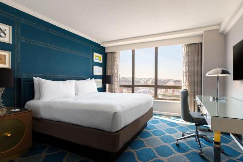 a hotel room with a bed and a desk and a window at The Ven at Embassy Row, Washington, D.C., a Tribute Portfolio Hotel in Washington