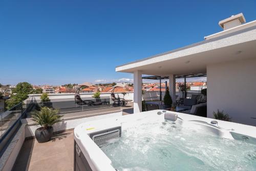a hot tub on the balcony of a house at Leonardo Luxury Residence 2 Penthouse with jacuzzi in Zadar