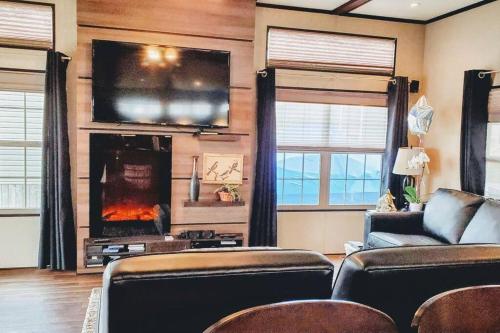 a living room with a couch and a fire place at Water Front very spacious Cottage on Rice Lake with 5 Star Golf Resort in Keene