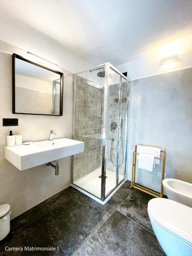 a bathroom with a glass shower and a sink at Le Camere Di Paolo in Riomaggiore