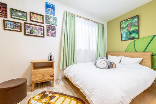 Schlafzimmer mit einem Bett und einem Fenster in der Unterkunft CuteFamilyHouse! 3LDK 6minShinjuku 3minJRsta Cozy,Fun,Bright! KidsFree Under6yrs in Tokio