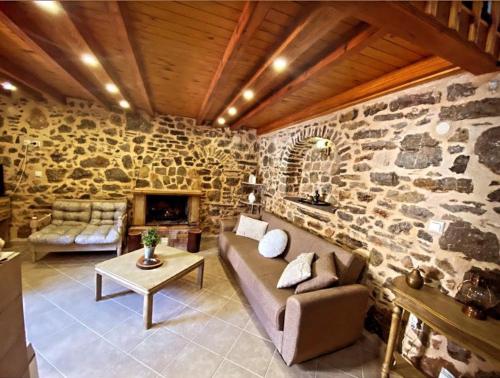 a living room with a stone wall at August castle house in Mestá