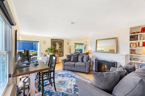 a living room with a couch and a fireplace at Magnolia on the Hill in Seattle