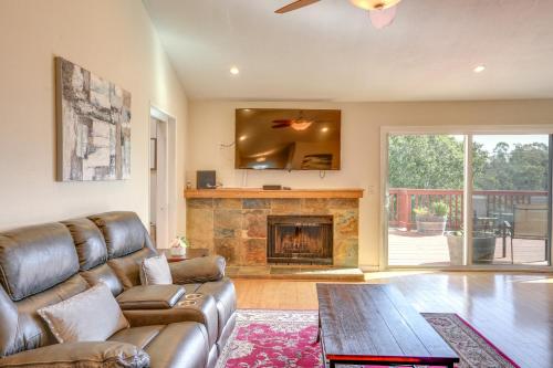 a living room with a couch and a fireplace at Vallejo Home with Spacious Deck, Hot Tub and Views in Vallejo
