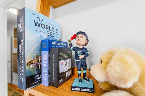 a stuffed teddy bear sitting next to two books at Magnolia on the Hill in Seattle