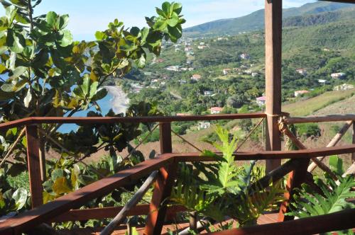 a view from the balcony of a house with a view of a valley at Mango Island Lodges in Saint Joseph