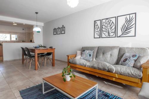 ein Wohnzimmer mit einem Sofa und einem Tisch in der Unterkunft Alojamiento Amor Amarillo in El Bolsón