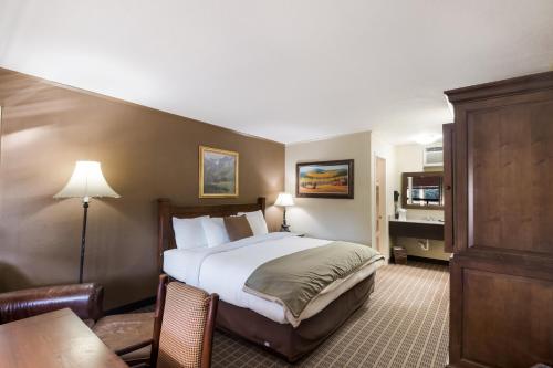 a hotel room with a bed and a desk at The Inn at Tomichi Village in Gunnison