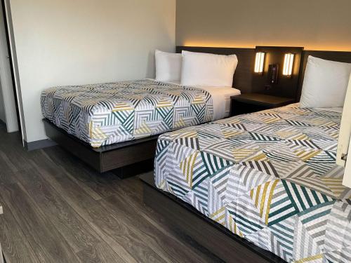 a hotel room with two beds next to each other at Motel 6-Ely, NV in Ely