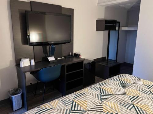 a hotel room with a desk with a tv and a bed at Motel 6-Ely, NV in Ely