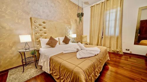 Un dormitorio con una cama con toallas blancas. en Vitti's Home Verona en Verona
