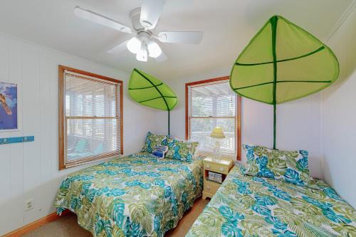 a bedroom with two beds and a ceiling fan at Dancing Dolphin 106 in Avon