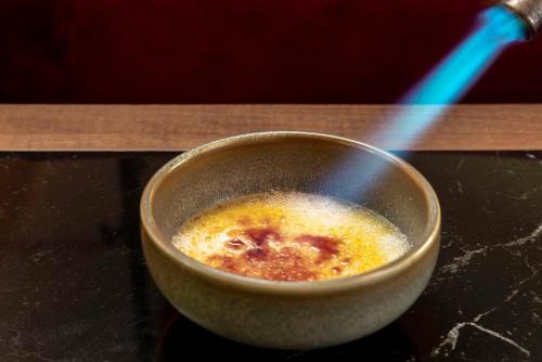 a bowl of food sitting on a table with a stirring at Radisson RED Madrid in Madrid