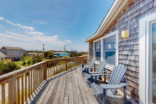 a deck with two chairs on a house at Dancing Dolphin 106 in Avon