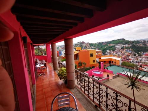 a balcony with a view of a pool and buildings at Hotel Chocolate Suites in Guanajuato