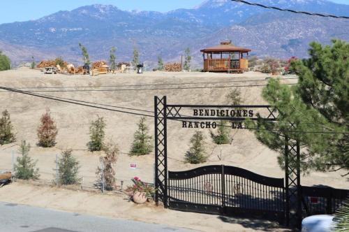 a gate to a yard with a gazebo at RV quiet place in the mountain in Hemet