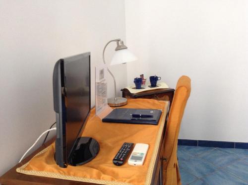 a desk with a computer monitor and a laptop on it at Hotel Floridiana in Amalfi