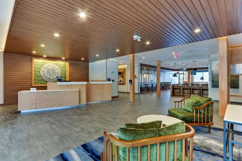 a lobby with chairs and a counter in a building at Fairfield Inn & Suites by Marriott Dallas Love Field in Dallas
