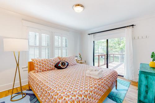a bedroom with a bed and a large window at Greenwood Getaway in Nashville
