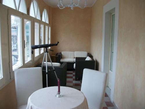 a room with a table and chairs and a camera at La Loggia Di Federico in Navelli