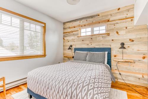 a bedroom with a bed and a wooden wall at Beach Oasis in Seaside