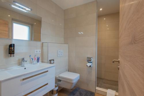 a bathroom with a toilet and a sink and a shower at M-A-S-Hotel in Stuttgart