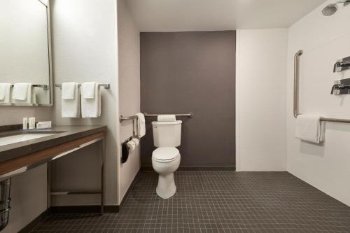a bathroom with a toilet and a sink at Courtyard by Marriott Toronto Mississauga/Meadowvale in Mississauga