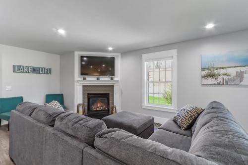 a living room with a couch and a fireplace at Williams Bay House - Cherry Street Retreat in Lake Geneva