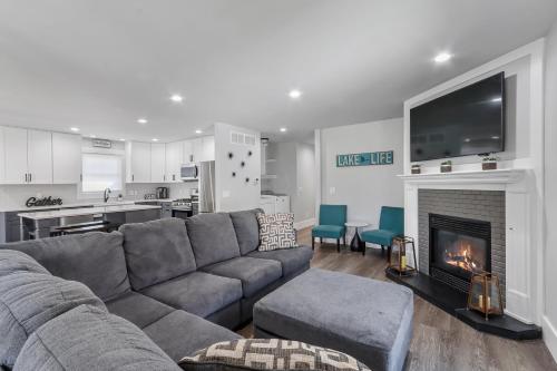 a living room with a couch and a fireplace at Williams Bay House - Cherry Street Retreat in Lake Geneva