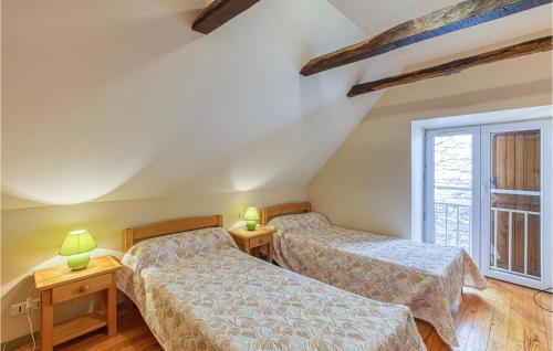 Castelnau-de-MandaillesにあるCozy Home In Castelnau D Mandailles With Kitchenのベッドルーム1室(ベッド2台、窓付)