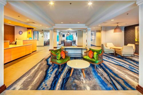 a hotel lobby with two chairs and a table at Fairfield by Marriott at Lakewood Ranch - Sarasota in Sarasota