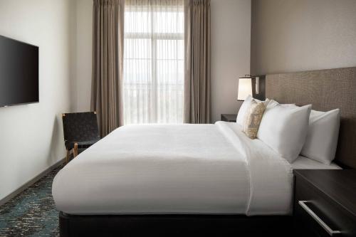 a hotel room with a large bed and a window at Residence Inn Los Angeles Glendale in Glendale