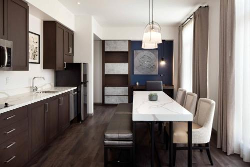a kitchen with a table and chairs in a room at Residence Inn Los Angeles Glendale in Glendale