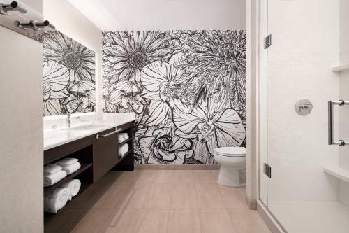 a bathroom with a black and white flower wallpaper at Residence Inn Los Angeles Glendale in Glendale