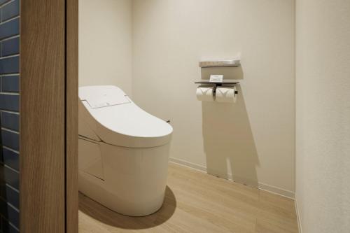 a bathroom with a white toilet in a room at Fairfield by Marriott Hiroshima Sera in Sera