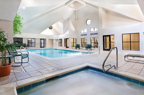 a pool in a building with a swimming pool at Staybridge Suites - Charlotte Ballantyne by IHG in Charlotte